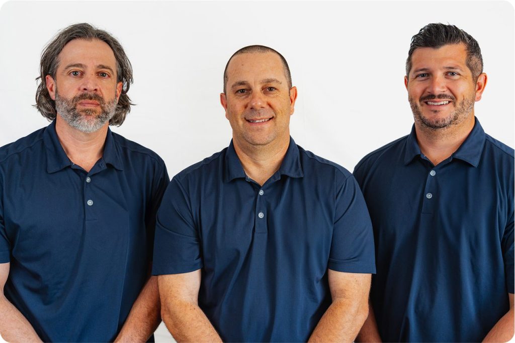 DLM management team standing together in blue uniform